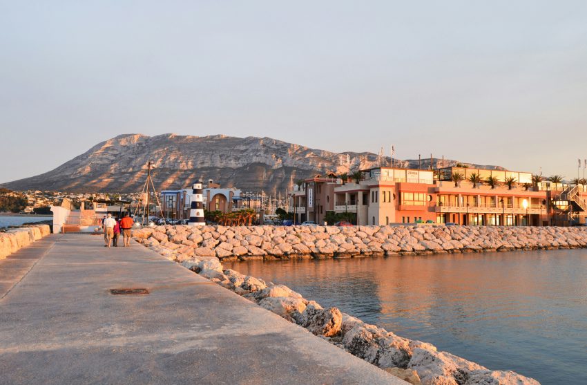 Seafront promenade in Denia with marina and colourful houses