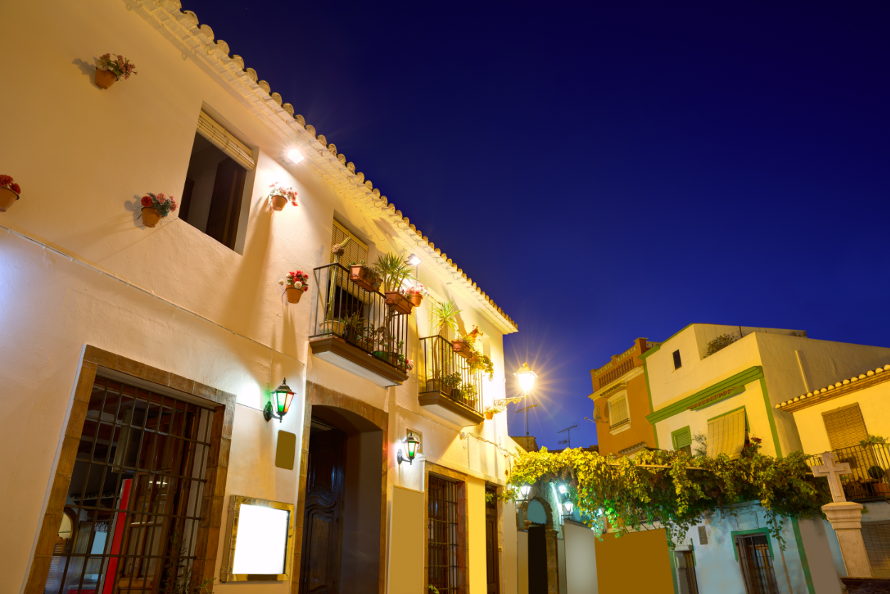 Historic street in Dénia old town illuminated at night