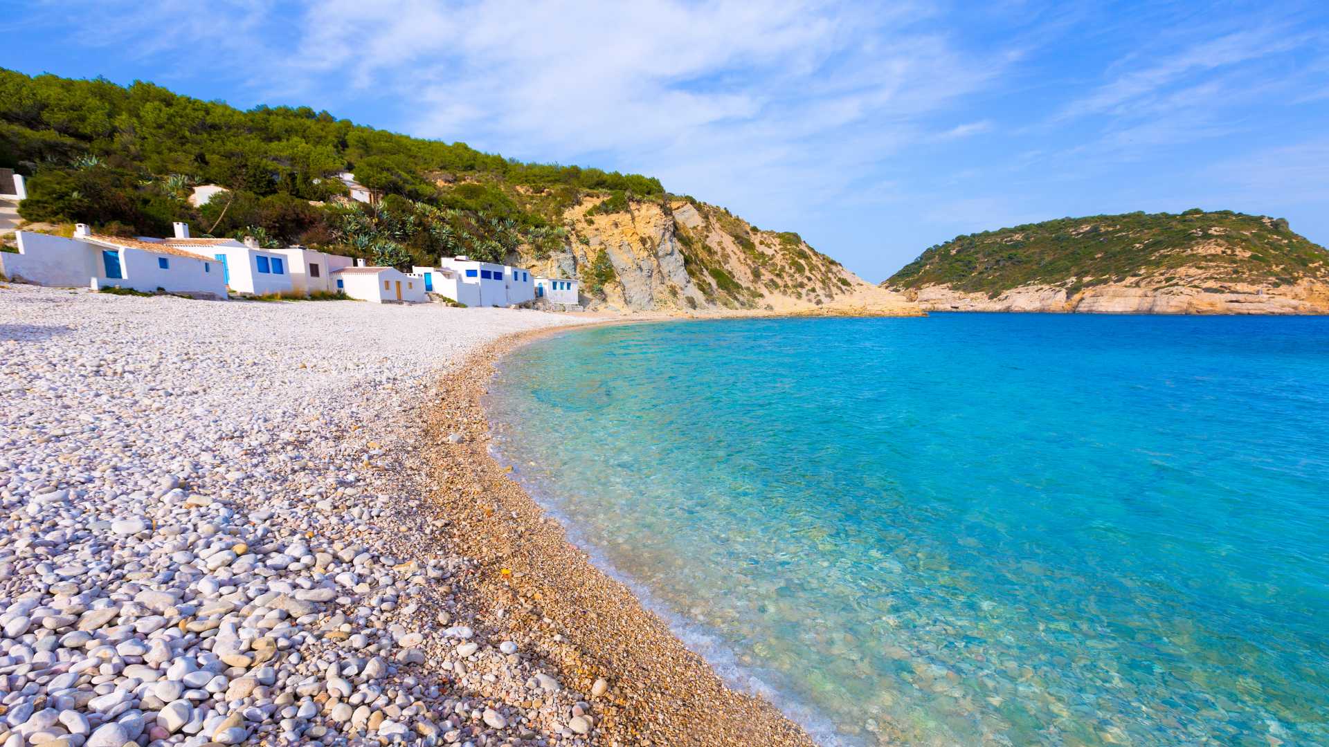 Pebble beach in Jávea with Mediterranean coastline