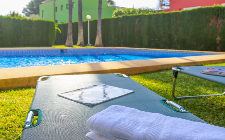 Swimming pool with sun loungers at apartment Alquería Sol in Dénia