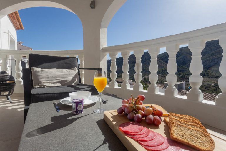 Covered terrace with outdoor dining table at Villa Vino in Pedreguer