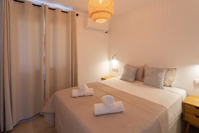 Bedroom with double bed and bedside tables at apartment El Patio in Dénia