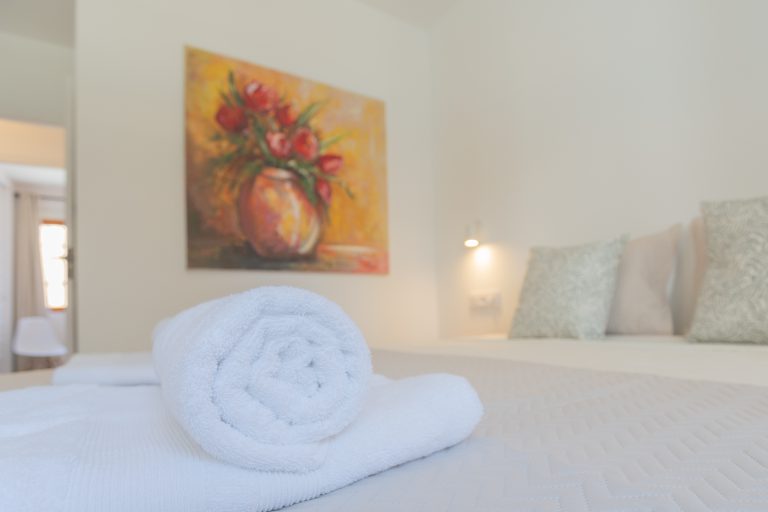 Bedroom with bed and towels at apartment El Patio in Dénia