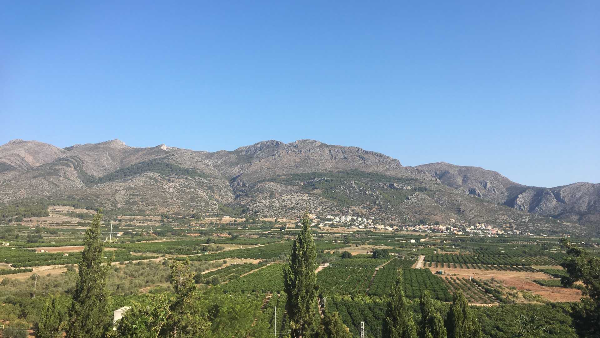 Valley landscape near Orba with mountains and green countryside