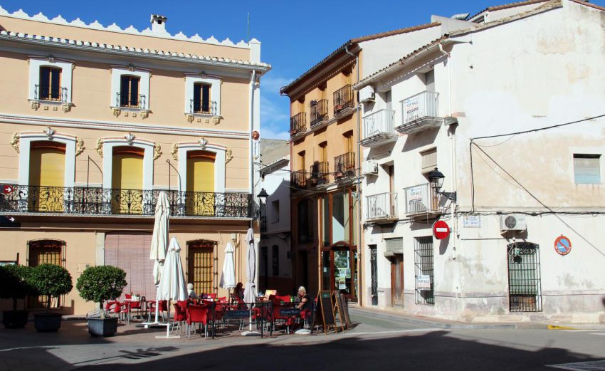 Traditional town square in Orba with colourful Spanish buildings