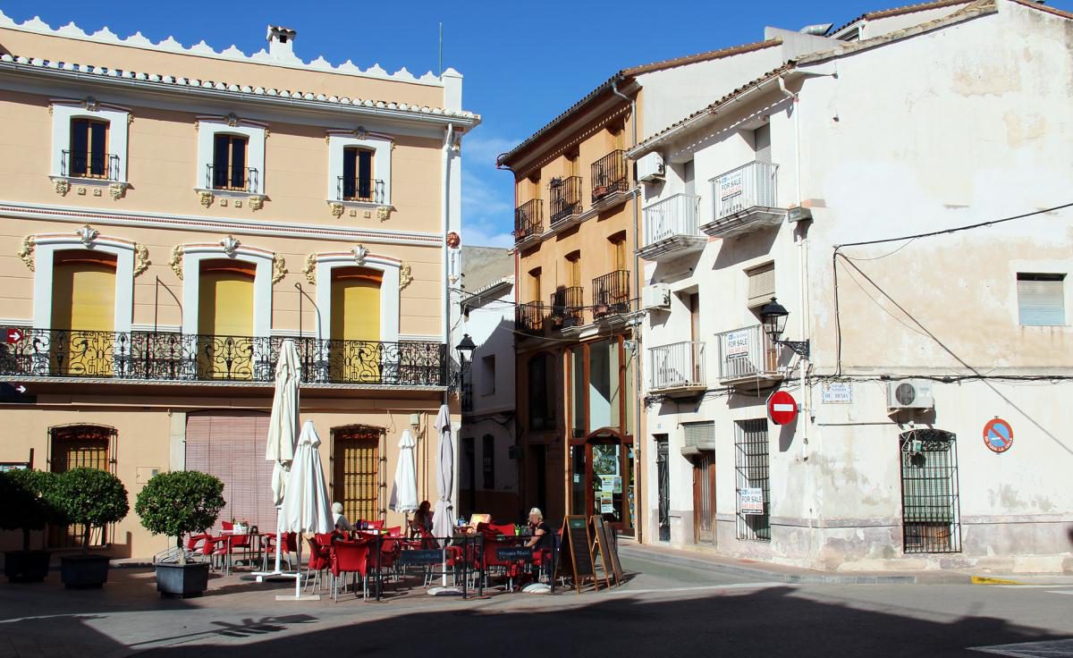 Traditional town square in Orba with colourful Spanish buildings