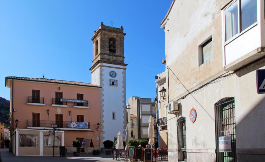 Church square in Orba village with traditional whitewashed houses