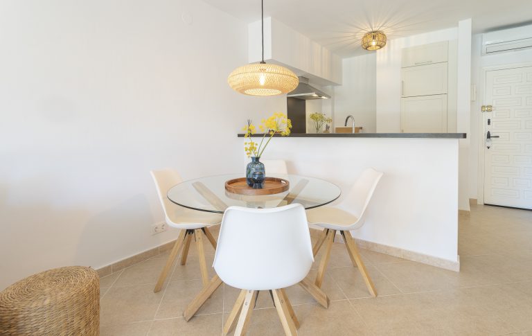 Dining table and chairs in living area at apartment Retiro Sol A1 in Dénia