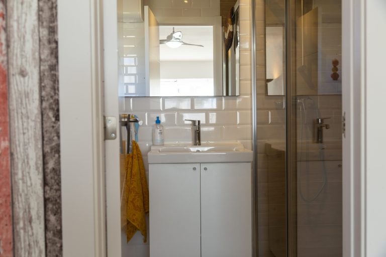 Bathroom with toilet and storage cabinet at apartment Retiro Sol A05 in Dénia